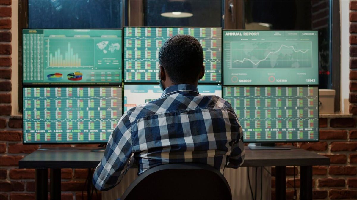 A Man Is Monitoring the Trading Graph on His Desk