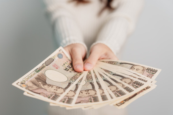 hand holding Japanese Yen banknote stack. Thousand Yen money