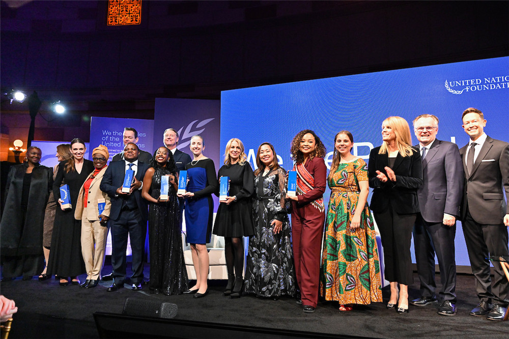 A group of global leaders, changemakers, and visionaries standing on stage