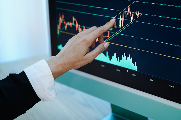 Trader woman studying stock market at home