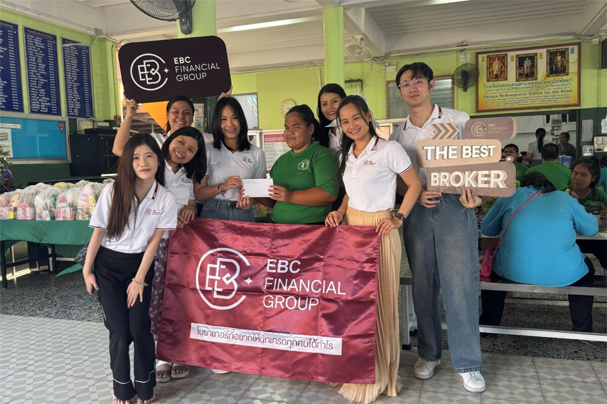 EBC volunteers pose with a banner and supplies at a community centre