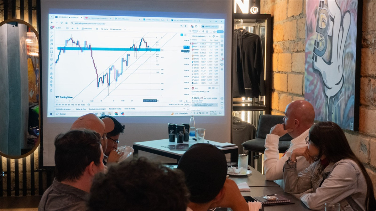 Attendees watch a stock presentation at EBC's exchange